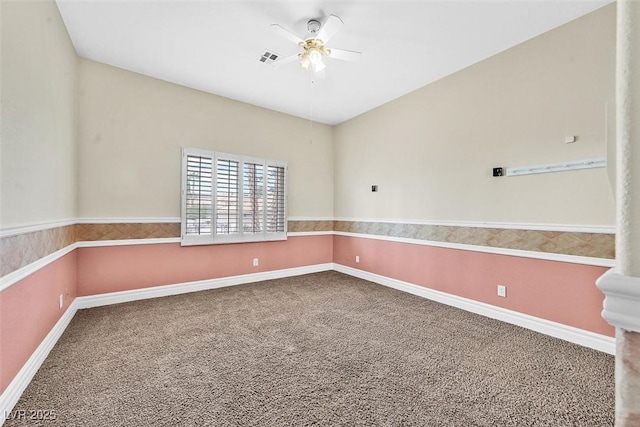 unfurnished room featuring ceiling fan and carpet