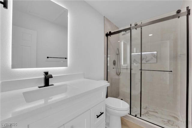 bathroom featuring vanity, toilet, and a shower with shower door