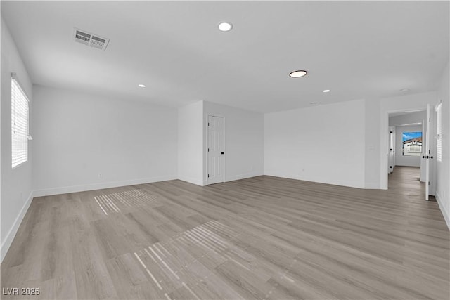 spare room featuring light hardwood / wood-style flooring