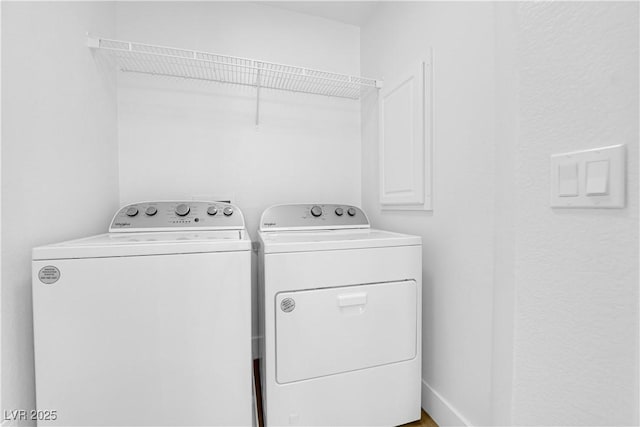 laundry room with washing machine and clothes dryer