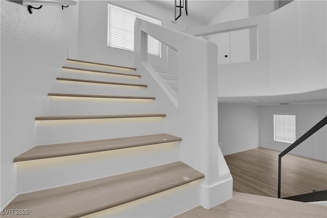 staircase with hardwood / wood-style floors