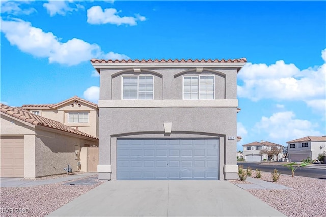 mediterranean / spanish house with a garage