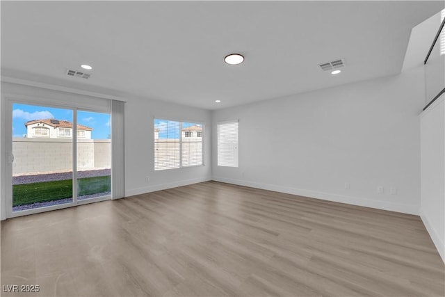 unfurnished room with light wood-type flooring