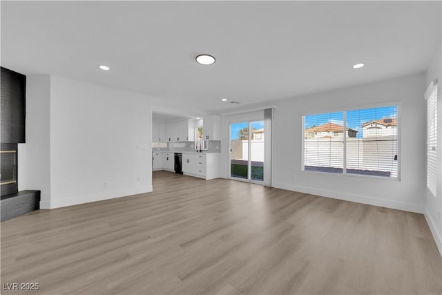 unfurnished living room with light hardwood / wood-style flooring