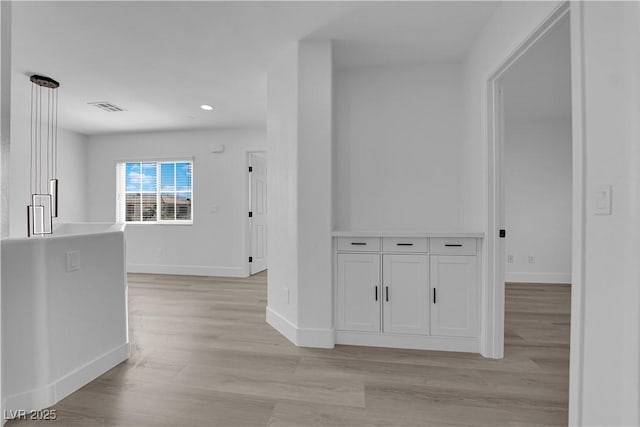 hall with light hardwood / wood-style floors