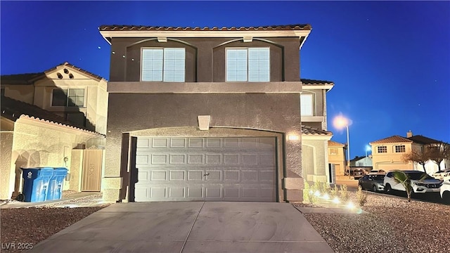 mediterranean / spanish-style home featuring a garage