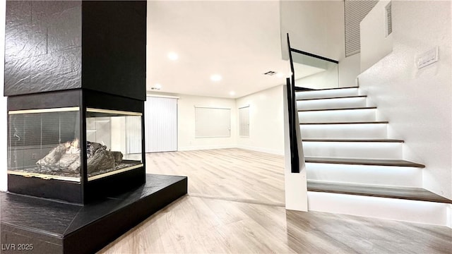 stairs with hardwood / wood-style floors