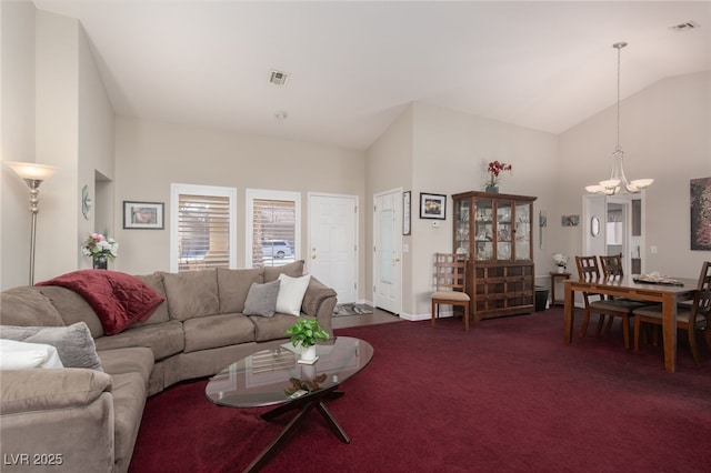 living room featuring an inviting chandelier, high vaulted ceiling, and dark carpet