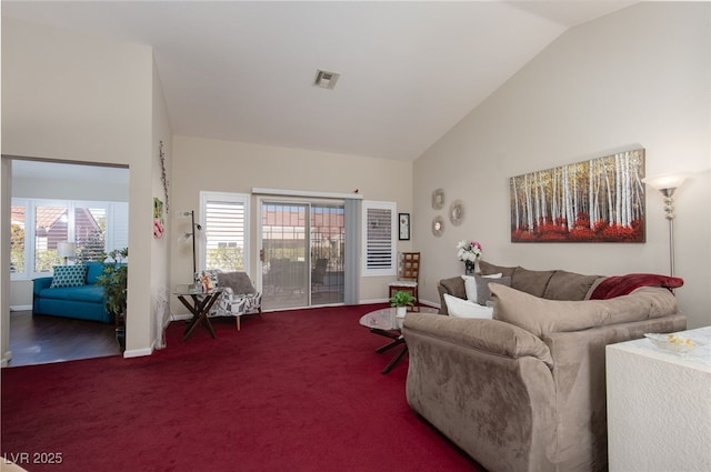 living room featuring high vaulted ceiling and carpet