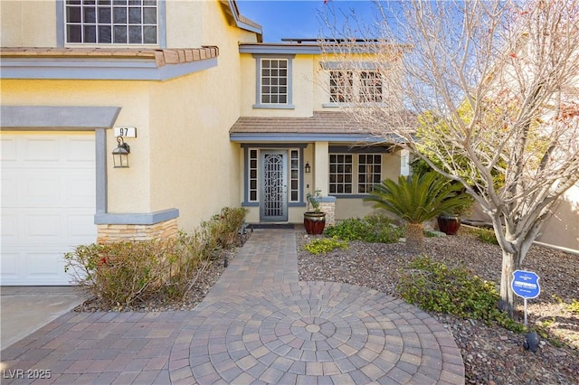 view of front of home featuring a garage and solar panels