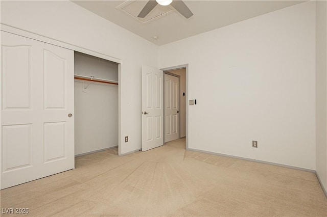 unfurnished bedroom featuring light colored carpet, a closet, and ceiling fan