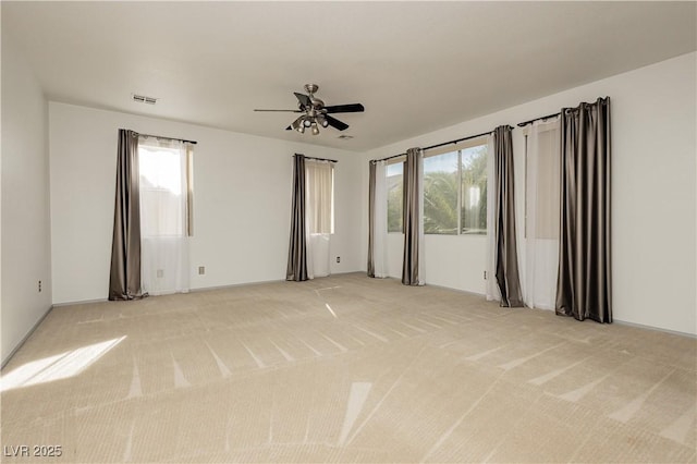 carpeted spare room featuring ceiling fan