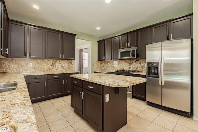 kitchen featuring dark brown cabinetry, light tile patterned flooring, and appliances with stainless steel finishes