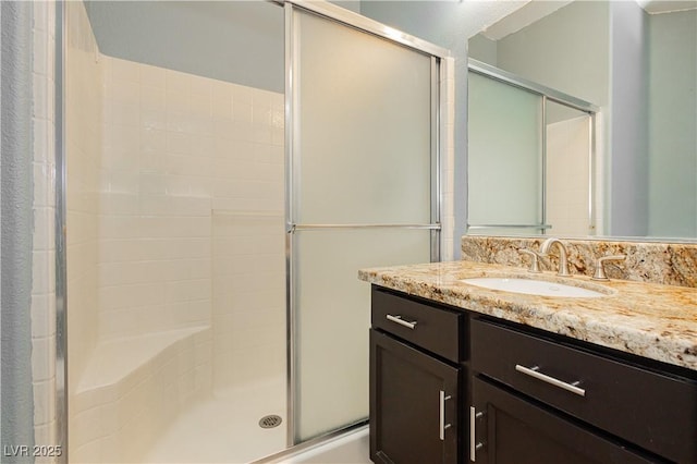 bathroom with vanity and a shower with shower door