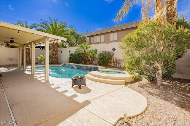 view of pool with a patio area, ceiling fan, and an in ground hot tub