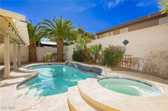 view of swimming pool with an in ground hot tub