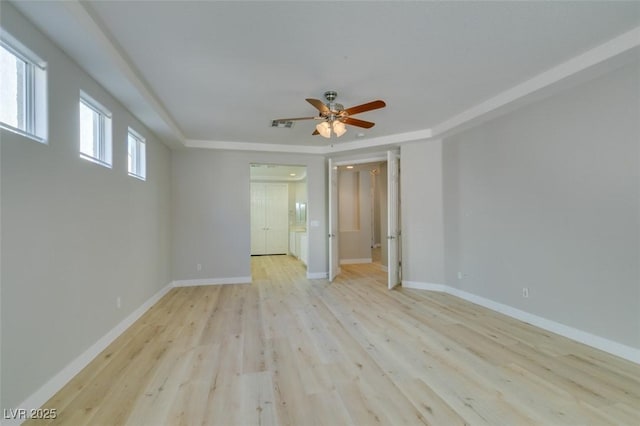 empty room featuring ceiling fan and light wood-type flooring