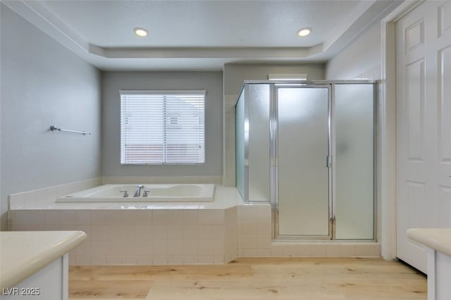 bathroom featuring independent shower and bath, vanity, and wood-type flooring