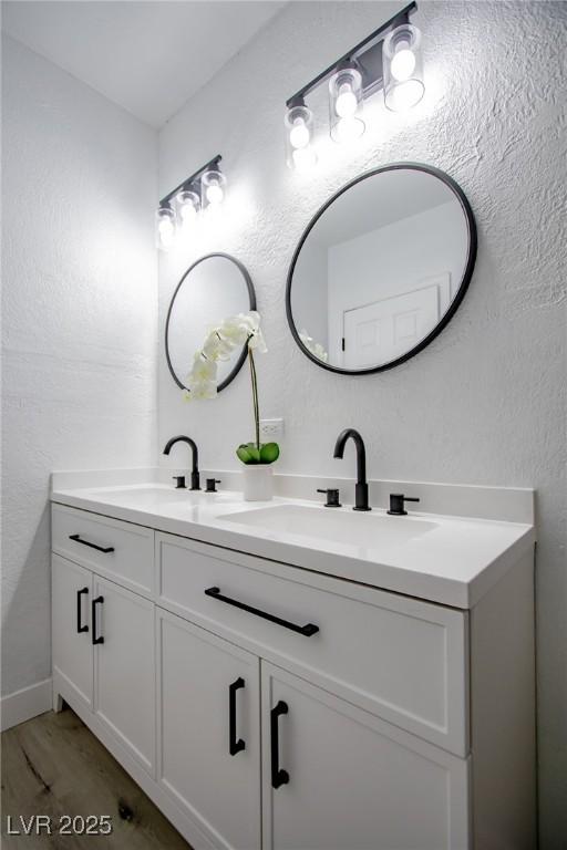 bathroom with vanity and hardwood / wood-style floors