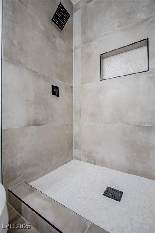 bathroom with a tile shower