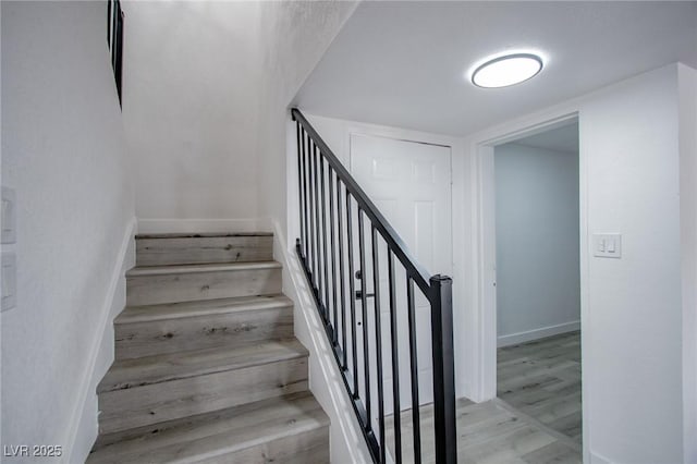 stairway with hardwood / wood-style floors