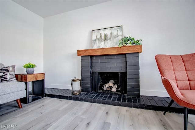 living area with hardwood / wood-style floors and a fireplace