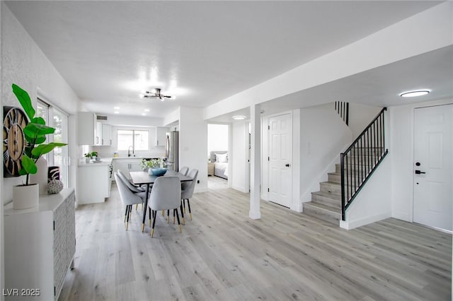 dining area featuring sink and light hardwood / wood-style floors