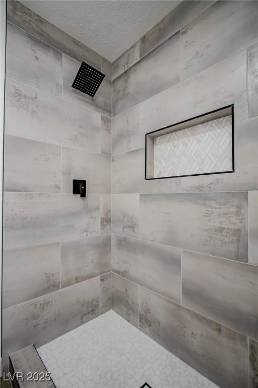 bathroom with tiled shower