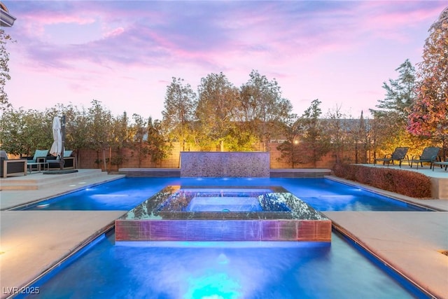 outdoor pool featuring a patio, an in ground hot tub, and fence