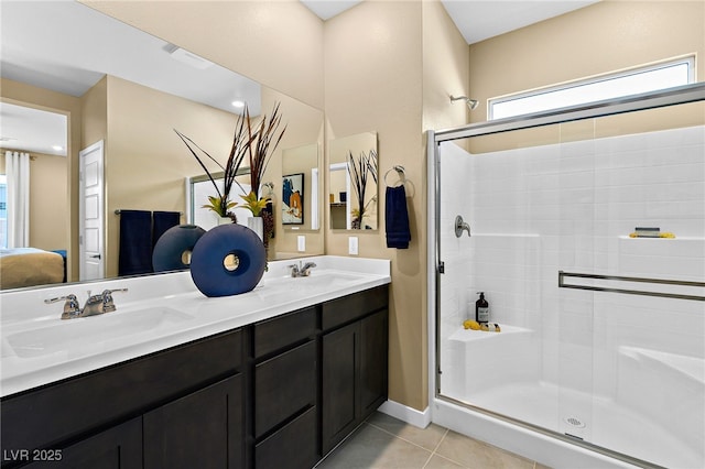 bathroom with vanity, a shower with shower door, and tile patterned floors