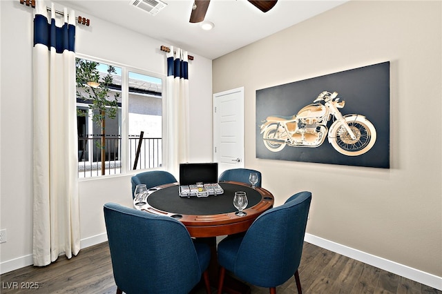 dining space featuring ceiling fan and dark hardwood / wood-style flooring