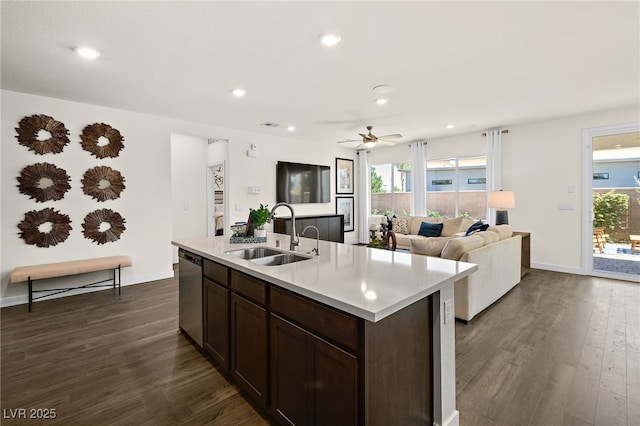 kitchen featuring sink, dark brown cabinets, stainless steel dishwasher, dark hardwood / wood-style flooring, and an island with sink