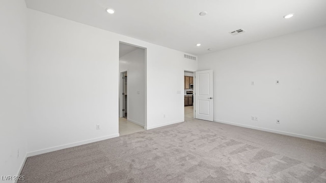4485 E Brusca Way, Pahrump, NV 89061 - unfurnished room featuring baseboards, light carpet, visible vents, and recessed lighting