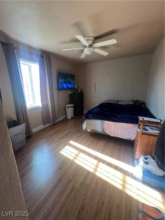 bedroom with hardwood / wood-style flooring and ceiling fan