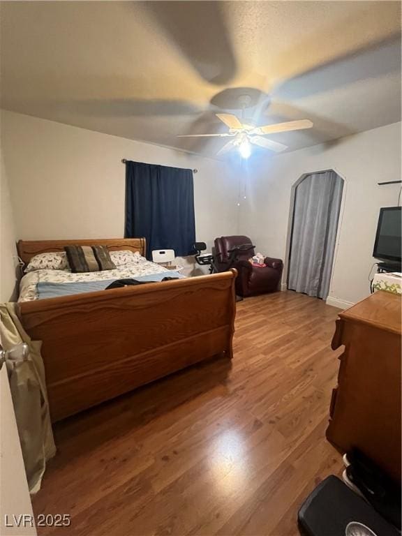 bedroom with hardwood / wood-style floors and ceiling fan