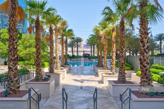 community pool with fence and a patio