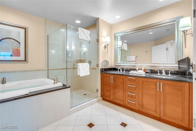 bathroom with a stall shower, a garden tub, tile patterned floors, double vanity, and recessed lighting