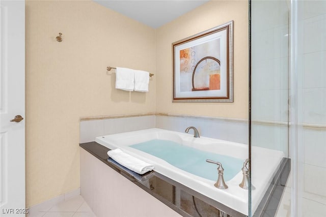full bath featuring a garden tub and tile patterned flooring