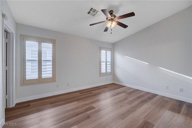 spare room featuring hardwood / wood-style floors and ceiling fan