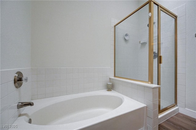 bathroom featuring hardwood / wood-style flooring and independent shower and bath