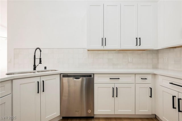 kitchen with white cabinetry, sink, tasteful backsplash, and dishwasher