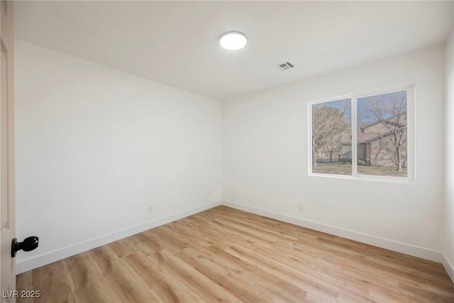 spare room featuring light hardwood / wood-style floors