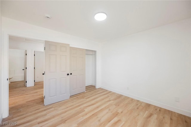 unfurnished bedroom with light hardwood / wood-style floors and a closet