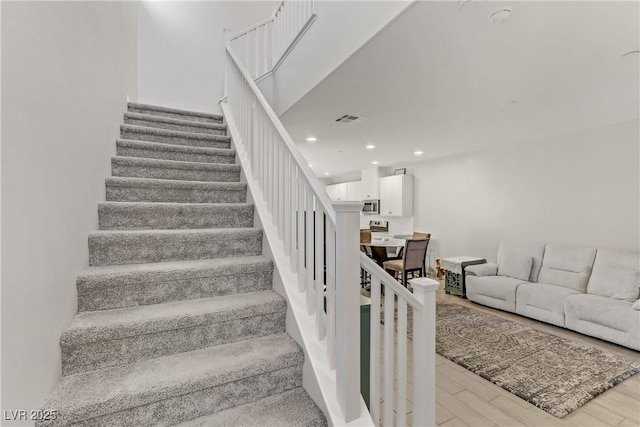 stairway featuring hardwood / wood-style flooring