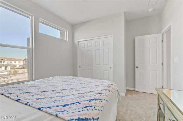 bedroom with light carpet and a closet