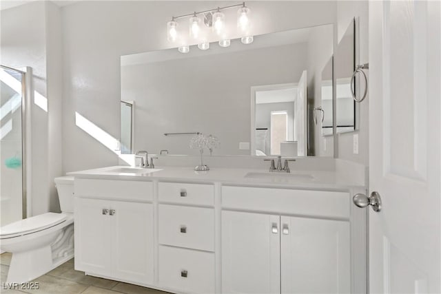 bathroom featuring tile patterned flooring, vanity, a shower with door, and toilet