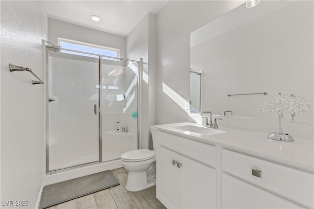 bathroom with vanity, toilet, and an enclosed shower