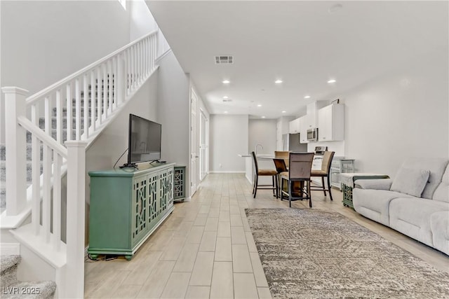 living room with wine cooler and light hardwood / wood-style floors