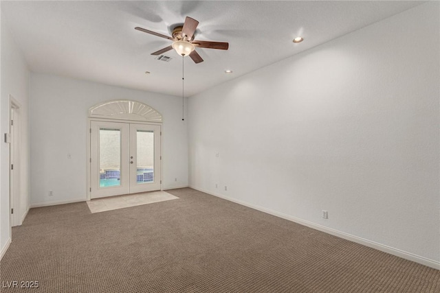 empty room with light carpet, french doors, and ceiling fan