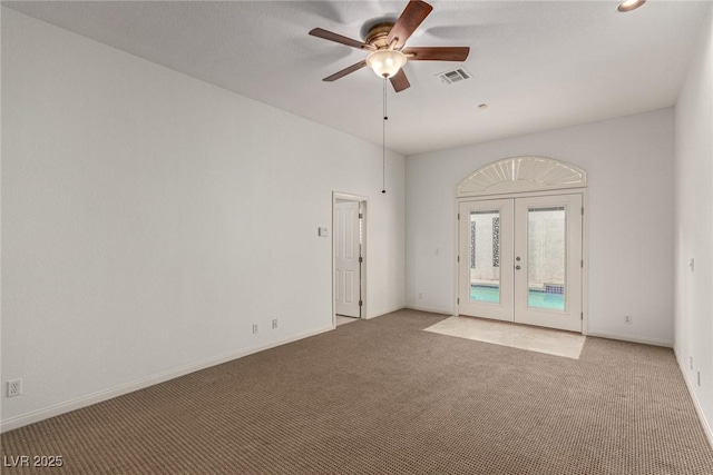 carpeted empty room with french doors and ceiling fan